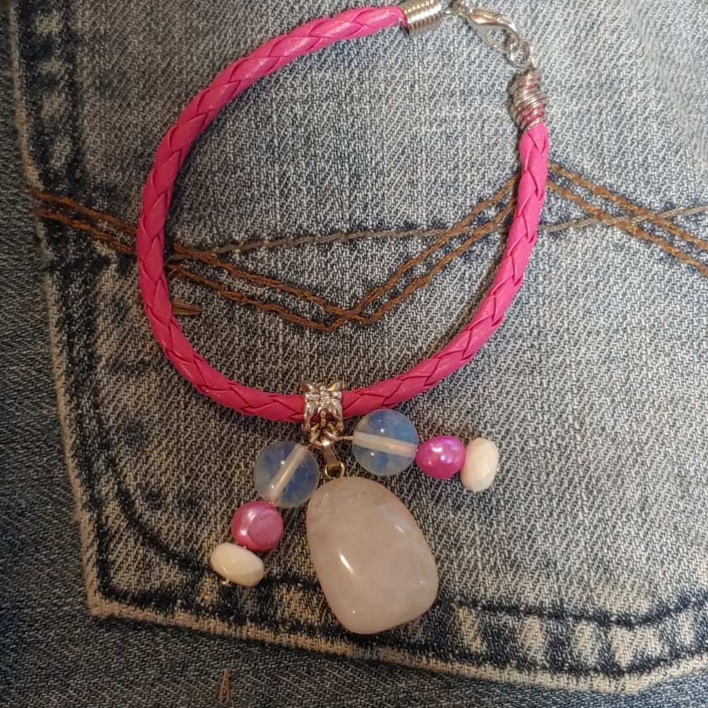 Pink leather braided cord bracelet.